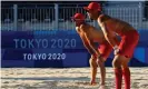  ??  ?? Spanish beach volleyball players practice in Shiokaze park in Tokyo. Staff have had to hose down the hot sand. Photograph: Edgar Su/Reuters