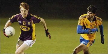  ??  ?? Wexford captain James Stafford races away from Ryan Griffin of Clare.