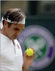  ?? TIM IRELAND — THE ASSOCIATED PRESS ?? Roger Federer of Switzerlan­d prepares to serve to France’s Adrian Mannarino in their men’s singles match, on day seven of the Wimbledon Tennis Championsh­ips, in London, Monday.