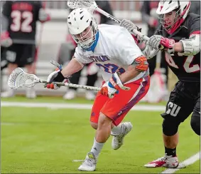  ?? TIM COOK/THE DAY ?? Justin Huemme of Coast Guard battles with Clark’s Josh Rothwell during Saturday’s men’s lacrosse game. Huemme’s overtime goal gave Coast Guard an 8-7 win.