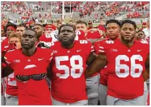  ??  ?? Ohio State players sing “Carmen Ohio” after their 77-31 seasonopen­ing victory over Oregon State on Saturday at Ohio Stadium in Columbus.