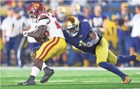  ?? MATT CASHORE/USA TODAY SPORTS ?? Linebacker Te’von Coney, tackling USC’s Ronald Jones II, bypassed the NFL draft after leading Notre Dame in tackles with 116.