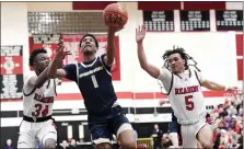  ?? BILL UHRICH - READING EAGLE ?? Spring-Ford’s E. J. Campbell splits the defense of the Red Knights’ Malik Osumanu, left, and Nick Chapman in a 55-32loss to Reading High in a PIAA Class 6A semifinal boys basketball game Tuesday at Coatesvill­e.