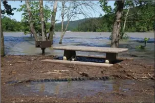  ?? The Sentinel-Record/Lorien E. Dahl ?? HIGH WATER: A picnic table and grill at Crystal Springs Day-Use Area were partially submerged in debris-filled water from Lake Ouachita on Monday.