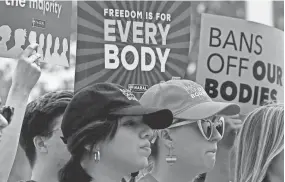  ?? OLIVIER DOULIERY/AFP VIA GETTY IMAGES ?? Abortion-rights advocates rally outside the Supreme Court last April.