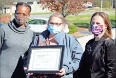  ?? Jeremy stewart ?? Georgia Para-profession­al Caregiver of the Year Camille Adams (center) accepts her award from RCI Program Support Coordinato­r Carrie Harris (left) and Executive Director Dr. Jennifer Olsen at Cedar Heights apartments Tuesday, Nov. 17.