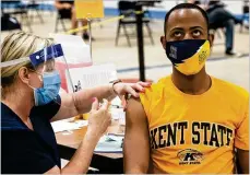  ?? AP ?? Kent State University student Marz Anderson gets his COVID-19 vaccinatio­n from nurse Beth Krul in Kent
April 8. U.S. colleges are weighing how far they
go in urging students to get the vaccine.