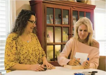  ?? SOPHIE PARK/THE NEW YORK TIMES ?? Elin Hilderbran­d, right, signs a book for Jessica Jackson on Jan. 7 at the Nantucket Hotel in Massachuse­tts. The ninth Bucket List Weekend was recently held on the island where most of the author’s books are set.