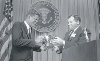  ?? AP ?? William J. Small presents a silver bowl to President John F. Kennedy on March 27, 1962.