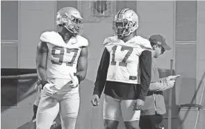  ?? ADAM CAIRNS/COLUMBUS DISPATCH ?? Ohio State defensive lineman Mitchell Melton talks to teammate Kenyatta Jackson during practice on Tuesday.