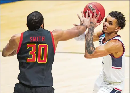  ?? ROBERT FRANKLIN/AP PHOTO ?? UConn’s James Bouknight, right, is defended by Maryland’s Galin Smith during the first half of Saturday night’s NCAA tournament first-round game at Mackey Arena in West Lafayette, Ind. The seventh-seeded Terps ousted the No. 10 Huskies 63-54.