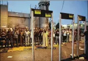  ?? MAHMOUD ILLEAN / AP ?? Palestinia­ns pray in front of mock metal detectors during a protest in Bethlehem on Sunday. Muslim leaders say Israel is trying to expand its control under the guise of security, a claim Israel denied.