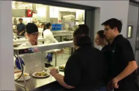  ?? CHAD FELTON — THE NEWS-HERALD ?? Jesseca Urban, left, and servers Maggie Myers, Sierra Nason and AJ Haffa, left to right, work together at Auburn Room Restaurant last week. The student-run restaurant is under the guidance of Auburn Career Center culinary arts program instructor Amy Ryan.