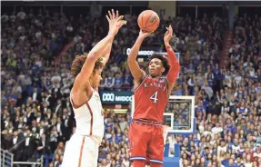  ?? DENNY MEDLEY/USA TODAY SPORTS ?? Kansas senior guard Devonte’ Graham, shooting against Texas’ Jericho Sims, averaged more than 17 points and seven assists.