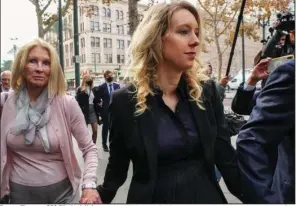  ?? (The New York Times/Jim Wilson) ?? Former Theranos CEO Elizabeth Holmes arrives Friday with family members at the federal courthouse in San Jose, Calif. “I regret my failings with every cell of my body,” Holmes said as she accepted her sentence.
