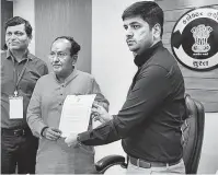  ?? PHOTO: PTI ?? BJP leader Mukesh Dalal receives the ‘certificat­e of election’ after he was elected unopposed recently from the Surat Lok Sabha seat, following the rejection of 12 nomination­s. Eight others withdrew nomination­s