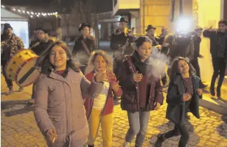  ?? —HERALDWIRE­SERVICES ?? OLD TRADITIONS: Young children light and smoke cigarettes, purchased by their parents, in the village of Vale de Salgueiro during the local Epiphany celebratio­ns Friday.