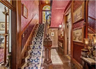  ?? Captured Listings photos ?? The front hall features ornate wallpaper and original woodwork.