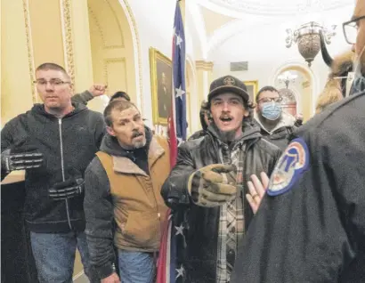  ?? MANUEL BALCE CENETA/AP ?? Violent protesters loyal to President Donald Trump, including Kevin Seefried (center), are confronted by U.S. Capitol Police officers outside the Senate Chamber inside the Capitol, Jan. 6, 2021.