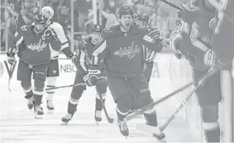  ?? Patrick Smith / Getty Images ?? Evgeny Kuznetsov, center, and the Capitals seize control in the third period of Game 5 against the visiting Penguins, scoring four goals to secure a 6-3 victory Saturday night.