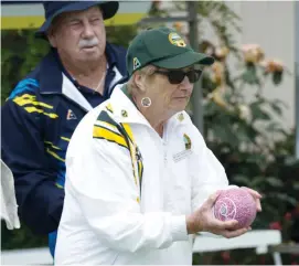  ??  ?? Neerim District’s Thelma Schroeder prepares to bowl as fellow players look on against Yallourn on Tuesday. It was a tough day, her rink trailing all day before going down 9/40.