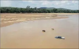  ??  ?? GO WITH THE TOW: The image of a grey Toyota Hilux van, in the middle of the Limpopo river, with the donkeys and suspected thieves wading in front of the vehicle, has been widely shared on social media.