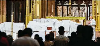  ?? Associated Press file photo ?? Mourners attend the blessing of ashes of Mexicans who died from COVID-19 during a July service at St. Patrick’s Cathedral in New York, before the remains were repatriate­d to Mexico.