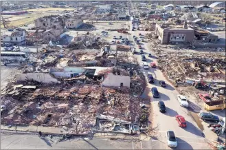  ?? Scott Olson / TNS ?? In an aerial view, homes and businesses are destroyed after a tornado ripped through town the previous evening on Saturday in Mayfield, Ky.