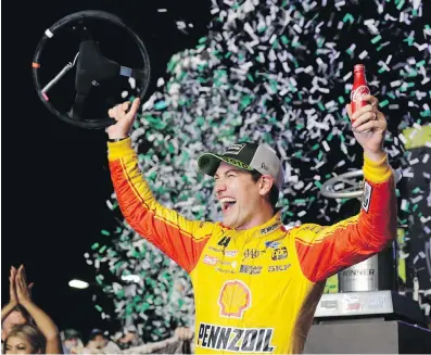  ??  ?? Joey Logano waves after winning the NASCAR Cup Series Championsh­ip race in Homestead, Florida, in November.