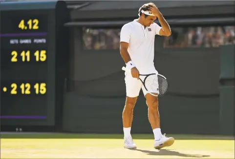  ?? Oli Scarff / AFP/Getty Images ?? Roger Federer reacts as he plays Kevin Anderson in the Wimbledon quarterfin­als on Wednesday. Federer, the defending champion, lost in 5 sets.