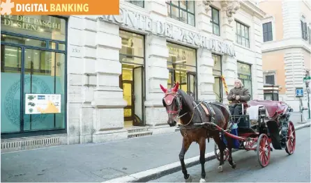  ?? — Reuters ?? A horse-drawn carriage passes a branch of Banca Monte dei Paschi di Siena in Rome.