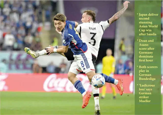  ?? — AFP ?? Japan’s midfielder Ritsu Doan and Germany’s defender David Raum fight for the ball during the Qatar 2022 World Cup Group E match at the Khalifa Internatio­nal Stadium in Doha.