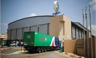  ?? (Amir Cohen/Reuters) ?? A TRUCK enters Tnuva’s logistic center in Kiryat Malachi.