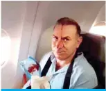  ?? — AFP ?? IN THE AIR: An image grab from a video released by staterun Iran Press news agency reportedly shows a passenger with blood dripping on his face, on an Iranian passenger plane after it was intercepte­d by a US F-15 while flying over Syria.