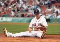  ?? Winslow Townson / Getty Images ?? The Red Sox’s Bobby Dalbec sits on the ground after not being able to tag out a runner at third base during the ninth inning against the Indians on Sunday in Boston.