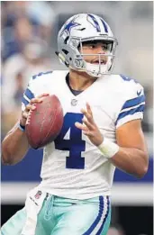  ?? TOM PENNINGTON/GETTY IMAGES ?? Some weapons will be gone this fall, but the Cowboys’ Dak Prescott will try to move the ball to the new contributo­rs.