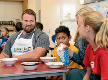  ??  ?? Timaru home town hero Tom Walsh helping serve the 30 millionth KickStart breakfast.