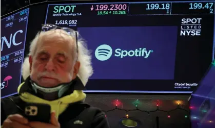  ?? Photograph: Brendan McDermid/Reuters ?? A screen displays trading informatio­n for Spotify as a trader works on the floor at the New York Stock Exchange on 4 December.