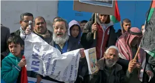  ?? AFP ?? CRY FOR HELP: Palestinia­ns protest outside a UN distributi­on centre in Rafah in the southern Gaza Strip, following the decision by the US government to froze tens of millions of dollars in contributi­ons to the UN Relief and Work Agency. The US has held...
