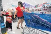  ?? RICARDO RAMIREZ BUXEDA/STAFF PHOTOGRAPH­ER ?? From left, Anthony Shedlock, 6, and Joseph Freistat, 3, shop Friday with their grandmothe­r Felicia Steele at Toys R Us in Kissimmee. Steele said she shopped mostly online.