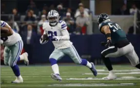  ?? RON JENKINS - THE ASSOCIATED PRESS ?? FILE - In this Sunday, Dec. 9, 2018, file photo, Dallas Cowboys running back Ezekiel Elliott (21) runs against the Philadelph­ia Eagles during the first half of an NFL football game in Arlington, Texas. If the Cowboys are for real, they will win their sixth straight game and clinch the NFC East at Indianapol­is on Sunday.