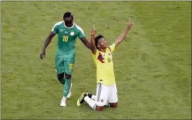  ?? GREGORIO BORGIA — THE ASSOCIATED PRESS ?? Colombia’s Juan Cuadrado, right, celebrates after winning the group H match between Senegal and Colombia, as Senegal’s Sadio Mane touches him, at the 2018 soccer World Cup in the Samara Arena in Samara, Russia, Thursday.