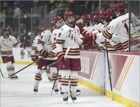  ?? ABBIE PARR — THE ASSOCIATED PRESS ?? Boston College forward Will Smith (6) is congratula­ted for his goal against Michigan during the first period of a national semifinal Thursday in St. Paul, Minn.