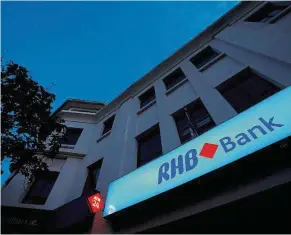  ??  ?? Stable ground: The RHB Bank logo is seen at its branch in Kuala Lumpur. Kenanga Research is cautiously optimistic the bank can achieve its financial year 2017 target. — Reuters