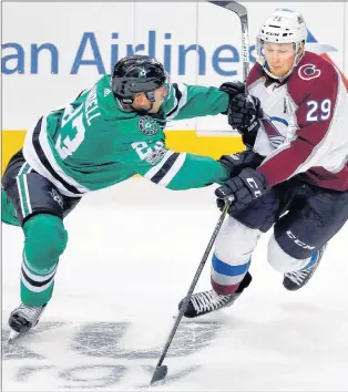  ?? AP PHOTO ?? Dallas Stars defenceman Esa Lindell gets his stick up on Nathan Mackinnon of the Colorado Avalanche in an NHL pre-season game this week. The league will be clamping down on the stickwork this season, especially slashing.