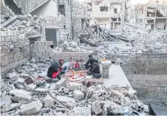  ?? AFP ?? Members of the displaced Syrian family of Tareq Abu Ziad, from the town of Ariha in the southern countrysid­e of the Idlib province, breaking their fast together.