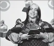  ?? [CHRIS PIZZELLO/ASSOCIATED PRESS FILE PHOTO] ?? In this Jan. 26 photo, Billie Eilish poses in the press room with her awards at the Grammy Awards in Los Angeles.
