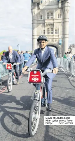  ??  ?? Mayor of London Sadiq Khan cycles across Tower Bridge DAVID MIRZOEFF