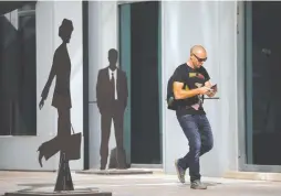  ?? (Amir Cohen/Reuters) ?? A MAN walks past sculptures in the hi-tech business area of Tel Aviv.