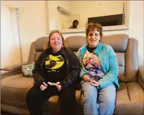  ?? Ginny Monk ?? Emily Forman, left and Bethanne Debellis sit on the couch in their new apartment in Bloomfield.